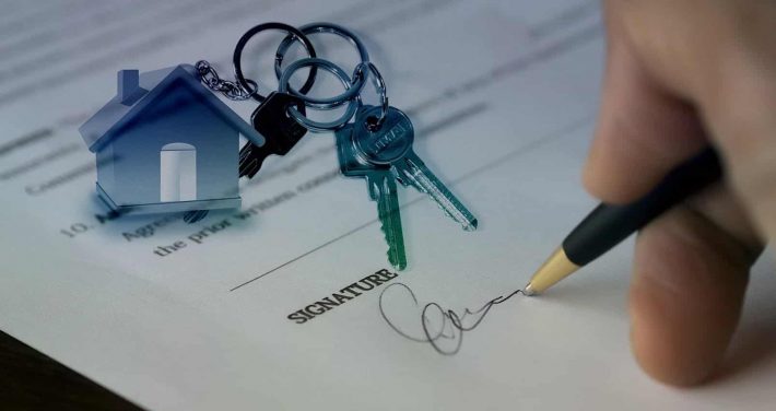 Étapes pour acheter un bien immobilier. Une signature de compromis et un trousseau de clefs.